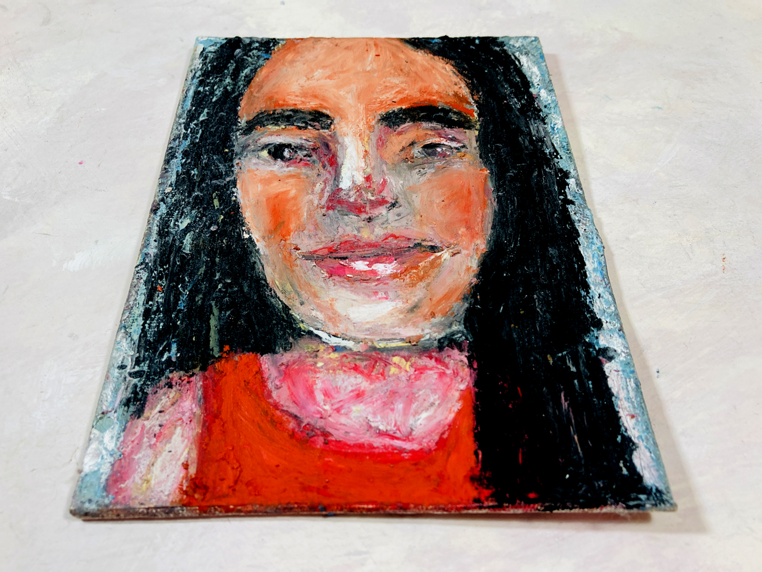 Oil pastel & oil paint portrait painting of a girl wearing red by Katie Jeanne Wood