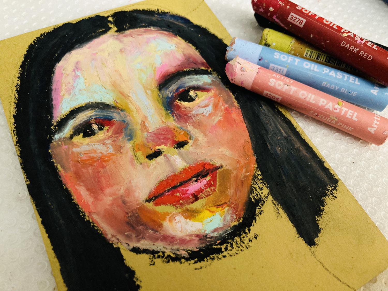 Oil pastel portrait painting in progress by Katie Jeanne Wood