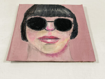 Oil pastel drawing of a woman wearing black sunglasses by Katie Jeanne Wood