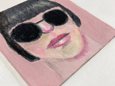 Oil pastel drawing of a woman wearing black sunglasses by Katie Jeanne Wood