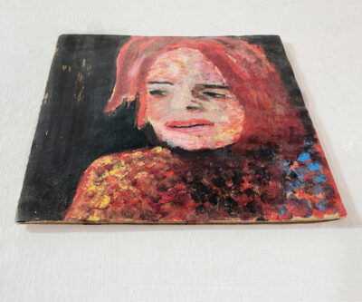 Acrylic portrait painting of a red haired woman on cardboard by Katie Jeanne Wood