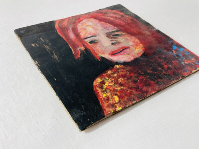 Acrylic portrait painting of a red haired woman on cardboard by Katie Jeanne Wood