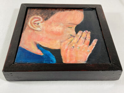 Acrylic portrait painting of a boy praying or meditating with a heavy handmade mahogany frame