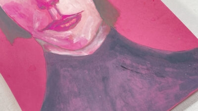 Expressive gouache portrait painting of a woman on pinkish red paper by Katie Jeanne Wood