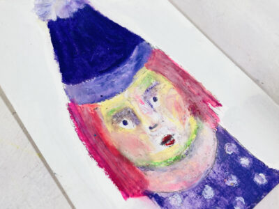 Oil pastel drawing of a girl wearing a purple winter hat.